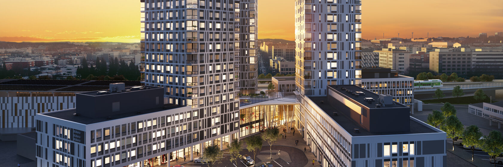 Moderni Kuopion Portti asuinkortteli ja ostoskeskus auringonlaskussa kaupungin horisontissa.