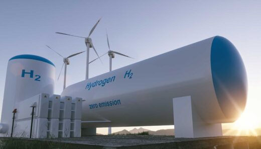 Hydrogen storage tanks in front and wind mills behind, early sunrise