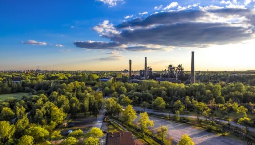 Industrial plant in a forestry landscape, blue, sunny sky