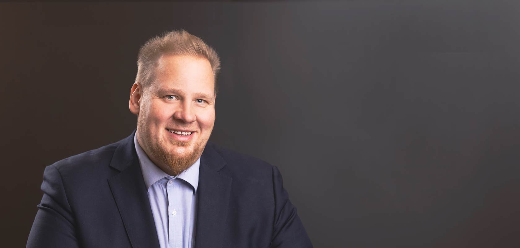 Picture of Sweco expert Ville-Veikko Karhunen against a dark background
