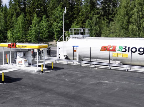 Truck biogas fueling station with large ST1 Biogas storage tank near forest
