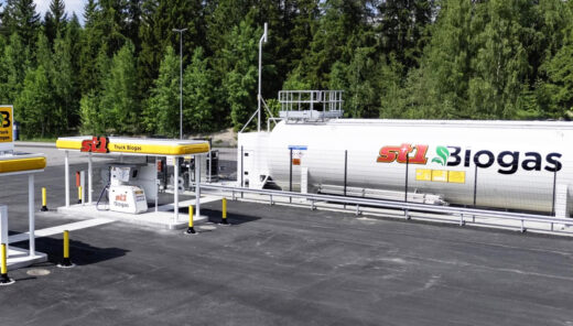 Truck biogas fueling station with large ST1 Biogas storage tank near forest