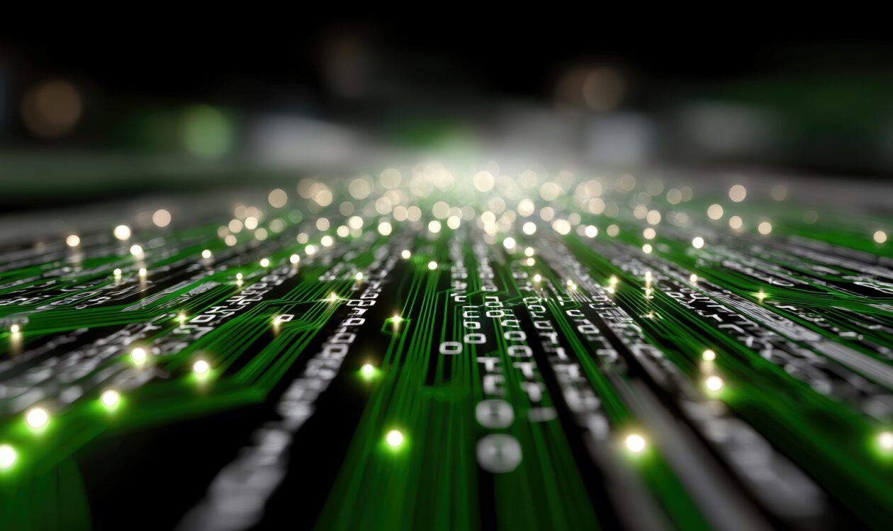 Lähikuva vihreästä piirilevystä, jossa kulkee digitaalisia johtoratoja ja pieniä valopisteitä, luoden abstraktin teknologia-aiheisen näkymän.