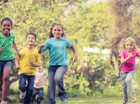 Childpren running outdoors facing the camera