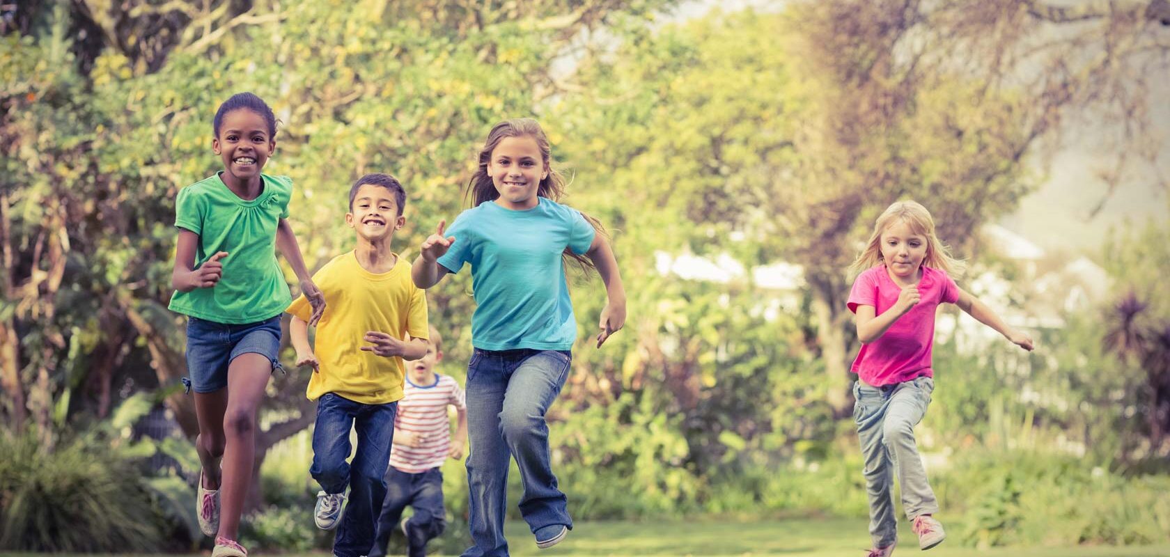 Childpren running outdoors facing the camera